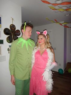 a man and woman dressed in costumes standing next to each other