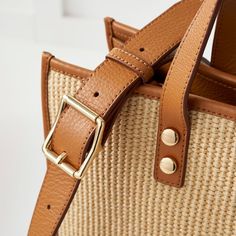 Crafted from a durable raffia-inspired fabric and high quality leather, our Essential Raffia Tote features a spacious, open-tote design with leather carry handles and an adjustable leather crossbody strap that can be swapped out for one of our colorful straps to create your own style. Add an embroidered monogram to add a personal touch to your new everyday tote.    15"w x 5"d x 12.5"h  Faux raffia with leather side panels and a soft linen lining.  Spot clean only with damp cloth.  Please see Pro Modern Beige Straw Bag With Double Handle, Everyday Leather Woven Shoulder Bag, Woven Leather Bag With Double Handle, Modern Beige Straw Bag For Shopping, Modern Beige Woven Straw Bag, Beige Top Handle Bag With Woven Leather, Casual Woven Leather Crossbody Satchel, Leather Bucket Bag With Detachable Strap In Natural Color, Natural Leather Bucket Bag With Detachable Strap