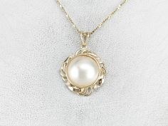 "Polished yellow gold is a luxurious accent in this Mabe Pearl pendant! This would make a wonderful piece for a bride and will look nice layered with other pendants. Bright diamonds provide a light, refreshing profile against the skin. This pendant does not come with the chain shown. Please feel free to contact us, we will help you find the perfect chain for your style and budget! Metal: 14K Yellow Gold Gem: Mabe Pearl Gem Measurements: 12.8 mm, Round Accents: 4 Diamonds totaling .06 Carats, H i Mabe Pearl, Puffy Heart, Vintage Pendant, Hand Engraving, Eternity Bands, Pearl Pendant, Diamond Pendant, The Chain, Bridal Jewelry