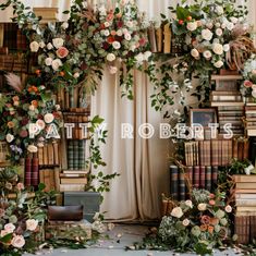 an arrangement of flowers and greenery decorates the bookshelves in this photo