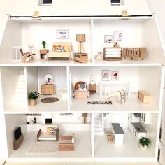 a doll house with all the furniture and accessories in it's white display case