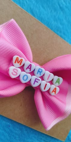 a pink bow with the word marina sofia written in small white letters on it