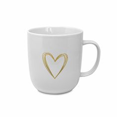 a white coffee cup with a gold heart on the front and bottom, sitting against a white background