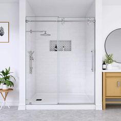 a bathroom with a sink, mirror and shower stall in the middle of the room