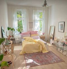 a bed room with a neatly made bed next to a window and a rug on the floor