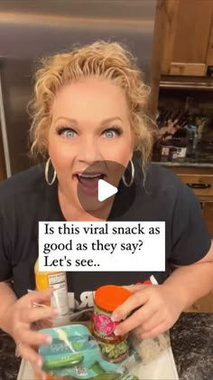 a woman making a funny face while holding food in her hand with the caption is this virtual snack as good as they say? let's see