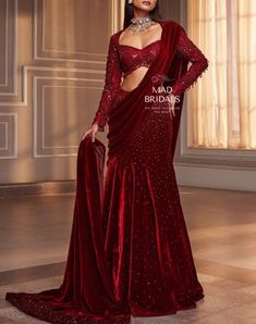 Get ready to dazzle in our Red Velvet Saree! It comes with a Hadwork blouse featuring trendy tassel detailing. The best part is It's a pre-stitched saree, and we've got you covered with stitched blouse pieces. You can choose any color and make any changes you like. Elevate your style effortlessly - click 'Buy Now' and make this stunning outfit yours today! Unveiling the Details: Color: Maroon Craftsmanship: Handwork Fabric: Pure Velvet **Important Notes All our items are meticulously handmade and uniquely tailored for our valued customers. Expect minor variations in the actual product compared to the displayed image. Product color may slightly vary due to photographic lighting sources or your monitor settings. Please be advised that once an order is placed, it cannot be canceled, and no ex Burgundy Saree, Manish Malhotra Bridal, Lehenga Sari, Baju Kahwin, Velvet Saree, Indian Fashion Trends, Indian Bride Outfits, Saree Designer, Fancy Sarees Party Wear