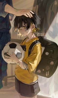 a person holding a soccer ball in their hand