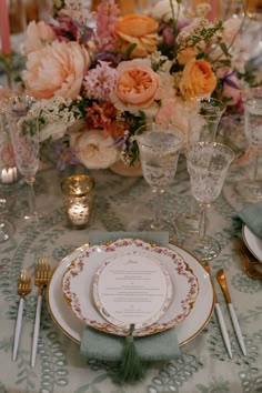 the table is set with plates and silverware