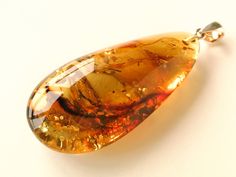 "Natural Baltic amber green color pendant shaped in drop form goes perfectly with every outfit! Perfect choice to brighten up office outfit or look even more beautiful on a special occassion! MATERIALS AND SIZE: Stone: 100% Natural Baltic Amber Other materials: silver 925 Weight: 11,6 g (0,4 oz) Bead size: 5,5 cm (2,16 in) x 2,6 cm (1,02 in) x 1,5 cm (0,59 in) PLEASE NOTE: All our amber production is made of natural amber. Amber is an unique stone and every piece is handmade, therefore there mig Pear-shaped Orange Jewelry Gift, Handmade Yellow Drop Jewelry, Orange Pear-shaped Jewelry For Gifts, Yellow Handmade Drop Jewelry, Teardrop Baltic Amber Necklace In Amber Color, Teardrop Baltic Amber Necklace, Yellow Baltic Amber Teardrop Jewelry, Yellow Teardrop Necklace For Gifts, Unique Yellow Teardrop Jewelry