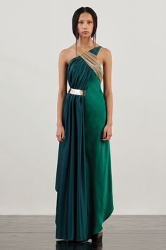 Green halter neck gown featuring a cross over front drape highlighted with a side metallic trim above a satin underbody. 
Components: 1
Pattern: Draped
Neckline: Halter Neck
Sleeve Type: Sleeveless
Fabric: Satin (66% Viscose 34% Modal)+ Silk Satin (100% Polyester)+ Lurex-Tulle (57% Metallic Yarn 43% Polyester)+ Mirror Metallic Trim (100% Polyester)
Color: Green
Other Details: 
Attached contrasting drape
Center back closure
Asymmetric hemline
Occasion: 
Cocktail,Party - Aza Fashions Halter Neck Kurti, Dress Draping, Halter Neck Gown, Gown Green, Draped Gown, Drape Gowns, Gown For Women, Gown Pattern, Green Gown