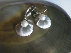 Handcrafted .925 Sterling Silver Dangle Earrings With 9 mm White Fresh Water Pearls Satin Finish.Dangle Earrings Details:Weight :6.5 gramsLength : 37.0 mm(1.46”)Circle Diameter: 19.0 mm(0.744")Stamped .925 ,HandcraftedThe set comes in a gift pouch and gift box. Hallmarked Sterling Silver Dangle Pearl Earrings, Classic Sterling Silver Nickel-free Pearl Earrings, Classic Nickel-free Sterling Silver Pearl Earrings, Classic Hallmarked Sterling Silver Pearl Earrings, Nickel-free White Gold Pearl Earrings In Sterling Silver, Silver Dangle Pearl Earrings For Anniversary, Hallmarked Round Sterling Silver Pearl Earrings, Nickel-free White Gold Sterling Silver Pearl Earrings, Wedding Earrings In Sterling Silver With Polished Finish