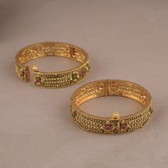 Indian Royal Antique Ruby Gold Plated Brass Bangles   is a timeless piece that will provide you with years of beautiful wear. The metal-brass alloy with gold plating is made to last. Indian Royal Antique Ruby Gold Plated Brass Bangles    is show-stopping and comes in traditional Indian design with gold plating and handwork.   NOTE: This Indian Royal Antique Ruby Gold Plated Brass Bangles    has been crafted by hand and may have slight irregularities or imperfections in color or embellishment. These irregularities are the result of human involvement in the process and add to the finished product's charm while ensuring you have a one-of-a-kind piece. Gold-tone Metal Bangle For Wedding, Gold Metal Bracelets With Intricate Design, Gold Metal Bracelets For Ceremonial Occasions, Antique Gold Metal Bracelets For Wedding, Gold Metal Temple Jewelry Bracelets, Gold Metal Temple Jewelry Bracelet, Heavy Antique Gold Bracelets, Gold Temple Jewelry Bracelet, Openable, Gold Plated Openable Gold Bracelets