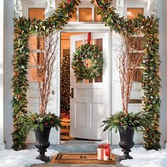 christmas wreaths on the front door of a house