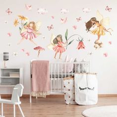 a baby's room with a crib and wall decals