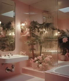 a bathroom with pink walls and flowers in the bathtub next to a mirror on the wall