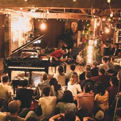 a group of people sitting in front of a piano