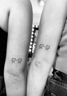 two people with matching tattoos on their arms