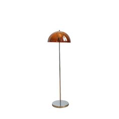 an orange floor lamp on a white background