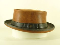 Tan Kangaroo Leather Pork Pie Hat    Hand crafted by John Whittaker (leather craftsman since 1972), of Cobb & Co Hats & Accessories in Melbourne, Australia. We create a wide range of formal & casual hats - check out our ebay store for more great hats & accessories!   The tan kangaroo leather Pork Pie Hat: *       Perfect for band gigs/formal events *       Made from top quality, genuine tan leather *       Made to stay in great shape, even with lots of handling & wear *       Brim is reinforced Rustic Adjustable Brown Top Hat, Vintage Leather Hat With Flat Bill, Vintage Leather Flat Bill Hat, Brown Western Style Top Hat For Formal Occasions, Brown Western Top Hat For Formal Occasions, Classic Brown Hat With Leather Sweatband, Brown Flat Brim Hat With Leather Lining, Formal Leather Brimmed Hat Bands, Rustic Brown Top Hat With Curved Brim