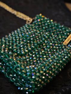 Experience the Luxury of Handmade Artistry with Lively Trends 🌟 Transform your style with our exquisite Emerald Green Crystal Beaded Bag, a masterpiece by Cloud Market Limited under the "Lively Trends" brand. This stunning bag, featuring three tones of shimmering crystals, is designed to add a touch of glamour and sophistication to any outfit. 👝 Bag Features: Dazzling Design: Our emerald green bag is adorned with three tones of shiny crystals, creating a captivating sparkle that will turn head Cheap Green Beaded Shoulder Bag, Handmade Green Shoulder Bag For Wedding, Handmade Green Shoulder Bag For Weddings, Shiny Crystals, Emerald Green Crystal, Bridal Bag, Crystal Clutch, Beaded Handbag, Beaded Bag