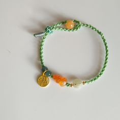 This Bracelet is made of Natural color yellow Jade Gourd. Original color and high quality.  Hand carved Jade Gourd with Jade bead and 14 k Gold filled Good Luck Fu ( 福）hanging on the Bracelet. One side made two Green Donut beads. Hand made beautiful knot with Green color string and it's a adjustable.  Gourd size 13*7 mm. Green Donut, Color Jade, Yellow Jade, Carved Jade, Knot Bracelet, Jade Bracelet, Jade Carving, Jade Beads, Leather Diy