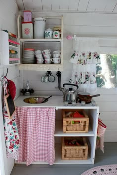 a small kitchen with lots of dishes on the shelves