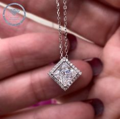 This stunning Halo Diamond Necklace features a brilliant 1.50 carat Princess Created Diamond, set in a delicate 925 sterling silver pendant. The 1 carat Round Cut Created Diamond adds extra sparkle and elegance to make this the perfect gift for any special occasion. Expertly crafted for maximum beauty. Chain Size: 18" (45.7 cm) including the clasp Pendant Size: 1.1 cm X 1.1 cm Main Stone Size: 7 mm X 7 mm (1.5 Carat) Main Stone Color: Clear White Main Necklace Color: Silver Main Stone Shape: Pri Square Diamond Necklace, Diamond Necklace Bridal, Diamond Necklace Gift, Halo Necklace, Necklace Art, Necklace Bridal, Art Deco Pendant, Square Diamond, Clear White