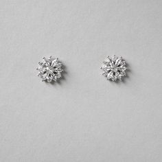 Bright CZ flower earrings for the bride or bridesmaids. Add a floral touch to your wedding day look with these beauties! They are .5 inches long and made with AAA CZ stones set in rhodium silver plating which makes them lead, nickel, and cadmium free. Delicate Cubic Zirconia Flower Earrings For Formal Occasions, Elegant Flower Crystal Earrings For Anniversary, Elegant Flower Shaped Crystal Earrings For Formal Occasions, Elegant Formal Flower Crystal Earrings, Elegant Formal Crystal Flower Earrings, Elegant Formal Flower-shaped Crystal Earrings, Formal Bridal Earrings With Cubic Zirconia In Flower Shape, Elegant Flower Crystal Earrings For Wedding, Formal Cubic Zirconia Flower Cluster Earrings