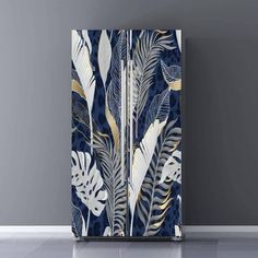 an image of a blue and white cabinet with leaves on it