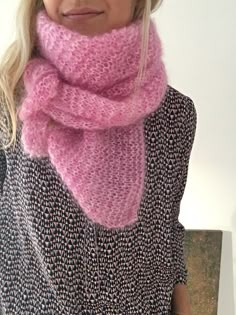 a woman wearing a pink knitted scarf