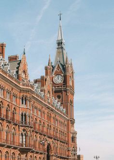 a large building with a clock on the front of it's face and steeple