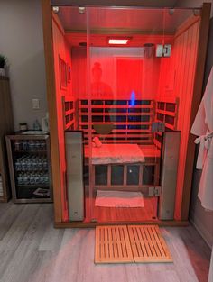 the inside of a sauna is lit up with red light