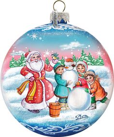 a glass ornament with santa and children making a snowman in the snow