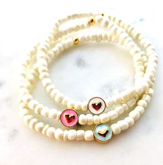 Black Friday, Cyber Monday Holiday Flash Sale True love.  This heart charm bracelet makes the perfect everyday statement. This whimsical enamel heart charm bracelet set is very sweet in an array of pink, blue and white heart 14k GP charms showcased by ivory opalescent seed beads!  This set is 7 inches.  If you need a custom size, please send a note at check-out. All jewelry orders arrive in special gift packaging, perfect for gifting. This simply elegant piece features a comfortable, super stret Cute White Jewelry With Charms, Heart-shaped Beaded Bracelets With Charms For Gift, Cute White Everyday Jewelry, Heart-shaped Beaded Bracelets With Charms As Gifts, White Heart Charm Jewelry For Everyday, Dainty White Bracelets With Charms, White Hypoallergenic Heart-shaped Jewelry, Heart-shaped Charms Beaded Bracelets For Jewelry Making, White Charm Bracelet With Heart Charm For Gift