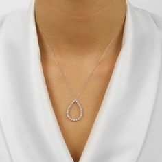 This elegant eternity pendant with its slim teardrop silhouette is decked with round brilliant cut diamonds 1/4, 1/2, or 1 CTW. Its gracefully floating effect on the collarbone is held in place by a sturdy chain. Luxurious and timeless, this diamond pendant is a must-have for any special occasion, its eye-catching fire and sparkle making it an ideal treasured gift. Visit your closest IDC location to make this extravagant diamond pendant a part of your collection—a timeless symbol of beauty and s Minimalist Teardrop Diamond Necklace With Accents, White Teardrop Necklace With Brilliant Cut, Minimalist Teardrop Brilliant Cut Necklace, Minimalist Teardrop Necklace With Brilliant Cut, Timeless Diamond Teardrop Pendant Necklace In Prong Setting, Teardrop Single Cut Diamond Necklace For Anniversary, Timeless Teardrop Diamond Necklace With Prong Setting, Fine Jewelry White Gold Teardrop Diamond Necklace, White Diamond Necklace With Brilliant Cut, Drop Shape