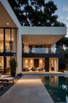 a modern house with an outdoor pool and lounge area in the foreground at dusk