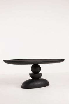 a black table sitting on top of a white floor