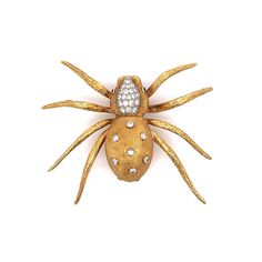 Estate Diamond Spider Brooch in 18k Solid Yellow Gold This Modern spider brooch adds a unique sparkle to any collection with its captivating design. Crafted in 18 karat yellow gold, the brooch features round brilliant cut diamond at its center, weighing .94 carats with a clarity of VS2 and an H color grade. The spider's body is adorned with additional bezel set and pave set diamonds totaling .06 carats, providing an extra layer of shimmer. The eyes of the spider are highlighted by two vibrant em Diamond Yellow Gold Brooches Fine Jewelry, Yellow Gold Diamond Brooch Fine Jewelry, Yellow Gold Diamond Brooches Fine Jewelry, Yellow Gold Diamond Brooch In Fine Jewelry Style, Fine Jewelry Diamond Brooch In Gold, Gold Diamond Brooches As Gift, Gift Yellow Gold Brooches With Single Cut Diamonds, Gold Brooches With Single Cut Diamonds For Gift, Spider Brooch