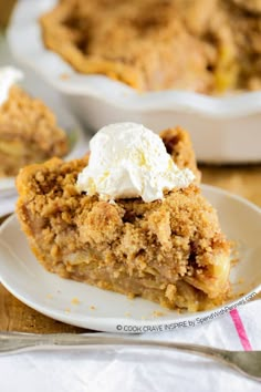 a piece of pie on a white plate with whipped cream and fork next to it