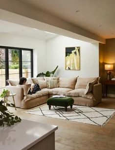 a living room filled with furniture and a large window