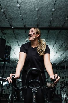 a woman riding on top of a stationary bike