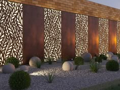 a wall made out of wood and stone with plants in the foreground next to it