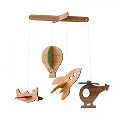 three wooden toys hanging from the ceiling with different shapes and colors on them, including a hot air balloon