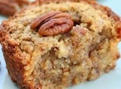 a close up of a piece of cake on a plate with pecans in the middle