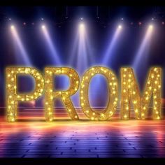 the words prom are lit up in front of bright lights on a stage with spotlights