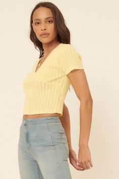 Ribbed pointelle knit top. Deep V neckline. Short sleeves. Scalloped edge at neckline, cuffs, and hem. Cropped length. Fitted silhouette. 70% Cotton, 30% Nylon. Imported. Designed in Los Angeles, CA. Model wears size S. Trendy Textured Knit Crop Top For Spring, Chic V-neck Pointelle Knit Top, Knit V-neck Top For Day Out, Fitted V-neck Knit Top For Day Out, Spring Cropped Crochet Top With Textured Knit, Knit V-neck Crop Top For Day Out, Fitted V-neck Crochet Top With Pointelle Knit, Fitted V-neck Textured Knit Top, Cropped Knit Top For Spring Day Out