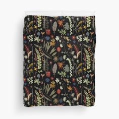 a black floral pattern with many different flowers and leaves on it duvet cover set