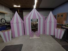 a pink and white striped tent sitting on top of a table next to a mirror