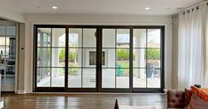 an empty living room with sliding glass doors